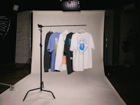 t - shirts hanging on a rack in front of a camera