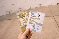 a person holding up a poster for the 2021 spring show